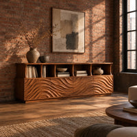 Tv stand with ripple carved front panels and four open display shelves in an industrial loft living room with exposed brick