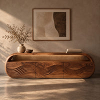 Corner detail of capsule shaped tv stand with three wave carved front panels beside wood, brass and linen samples