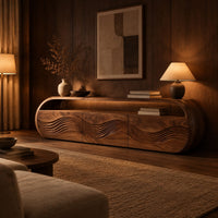 Capsule shaped tv stand with three wave carved front panels in an evening living room with walnut wall paneling