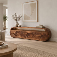 Capsule shaped tv stand with three wave carved front panels in a Scandinavian living room with white walls