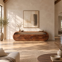 Capsule shaped tv stand with three wave carved front panels in a bright open plan living room