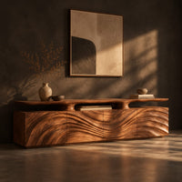 Low wooden tv stand with wave carved doors and a raised top shelf, three-quarter view showing the grain