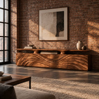 Low wooden tv stand with wave carved doors and a raised top shelf in an industrial loft living room with exposed brick