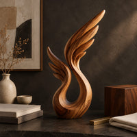 Corner detail of wing sculpture with layered feathers rising from an open loop beside wood, brass and linen samples