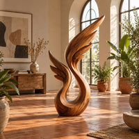 Wing sculpture with layered feathers rising from an open loop in a bright living room with arched windows and plants
