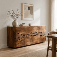 Sideboard with a winding carved band across warm grain front panels in a Scandinavian dining room with white walls