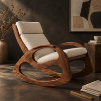 Corner detail of rocking chair with looped side frames, curved runners and long cushions beside wood, brass and linen samples