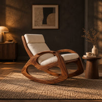 Rocking chair with looped side frames, curved runners and long cushions in a dark living room at golden hour