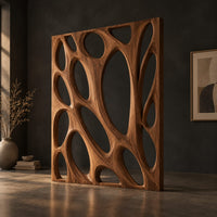 Tall wooden room divider panel with branching ribs and large oval openings, three-quarter view showing the grain