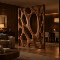 Tall wooden room divider panel with branching ribs and large oval openings in an evening open-plan living room with walnut wall paneling