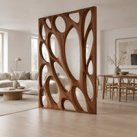 Tall wooden room divider panel with branching ribs and large oval openings in a Scandinavian open-plan living room with white walls