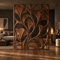 Openwork room divider with carved fan shaped leaves in a slim frame in a dark open-plan living room at golden hour