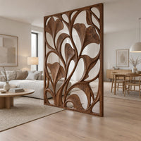 Openwork room divider with carved fan shaped leaves in a slim frame in a Scandinavian open-plan living room with white walls