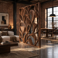 Openwork room divider with carved fan shaped leaves in a slim frame in an industrial loft open-plan living room with exposed brick