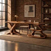 Desk with a root shaped leg and an open shelf pedestal in an industrial loft home office with exposed brick