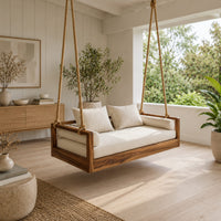Wooden swing hung from four thick ropes with a low solid wood frame in a Scandinavian porch with white walls