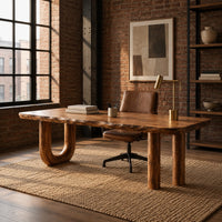 Plank top desk with a u shaped leg and two column legs in an industrial loft home office with exposed brick