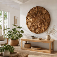 Round carved flower medallion with layers of overlapping petals in a bright sunroom with green plants