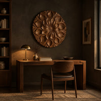 Round carved flower medallion with layers of overlapping petals above a desk in a dark study corner
