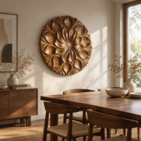Round carved flower medallion with layers of overlapping petals beside a dining table in natural light