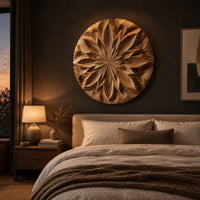 Round carved wood wall art with a radiating petal mandala pattern above a bed in a dusk lit bedroom