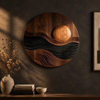 Round carved wall art with a sun disc over layered waves on a dark charcoal plaster wall