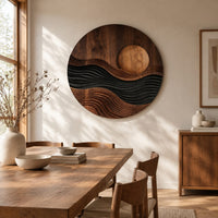 Round carved wall art with a sun disc over layered waves beside a dining table in natural light