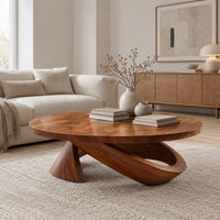 Round coffee table with a cone foot and a tilted open loop base in a Scandinavian living room with white walls