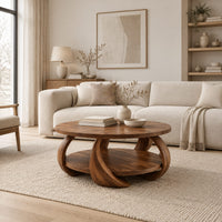Round coffee table with crescent shaped legs and a round lower shelf in a Scandinavian living room with white walls
