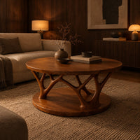 Circular coffee table with forked antler shaped legs above a wide disc base in an evening living room with walnut wall paneling