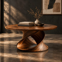 Round coffee table on a looping ribbon base, three-quarter view showing the grain