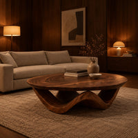 Round coffee table with a wavy ribbon base and swirled wood grain in an evening living room with walnut wall paneling