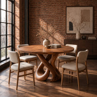 Round dining table on a sculpted base of two crossing wooden loops in an industrial loft dining room with exposed brick