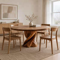 Round dining table with a twisted ribbon pedestal in a Scandinavian dining room with white walls