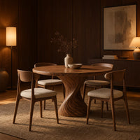 Round dining table with a twisted spiral carved pedestal in an evening dining room with walnut wall paneling