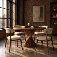 Round dining table with a twisted spiral carved pedestal in an industrial loft dining room with exposed brick