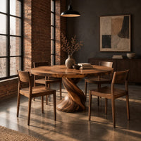 Round dining table on a twisted spiral pedestal base in an industrial loft dining room with exposed brick