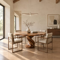 Round dining table on a twisted spiral pedestal base in a bright open plan dining room