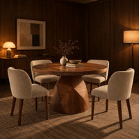 Circular dining table with a faceted bell shaped pedestal base in an evening dining room with walnut wall paneling