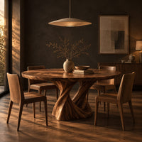 Round dining table on a twisted pedestal base in a dark dining room at golden hour