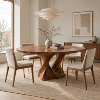 Round dining table on a twisted pedestal base in a Scandinavian dining room with white walls