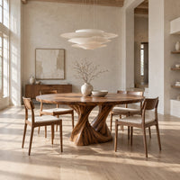 Round dining table on a twisted pedestal base in a bright open plan dining room