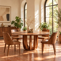 Round dining table on a pedestal made of arched wood columns in a bright dining room with arched windows and plants