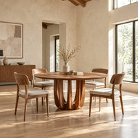 Round dining table on a pedestal made of arched wood columns in a bright open plan dining room