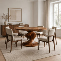 Round dining table with a spiral twist pedestal base and a wide flat foot in a Scandinavian dining room with white walls