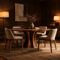 Round dining table with a flared pedestal base and a radiating grain top in an evening dining room with walnut wall paneling