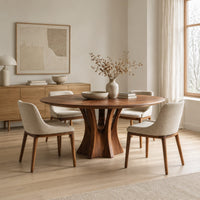 Round dining table with a flared pedestal base and a radiating grain top in a Scandinavian dining room with white walls