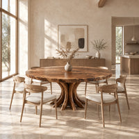 Circular dining table with a swirl grain top and flared trunk shaped legs in a bright open plan dining room