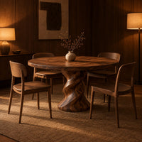 Round wooden dining table on a twisted pedestal base in an evening dining room with walnut wall paneling