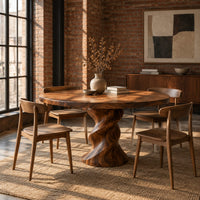 Round wooden dining table on a twisted pedestal base in an industrial loft dining room with exposed brick